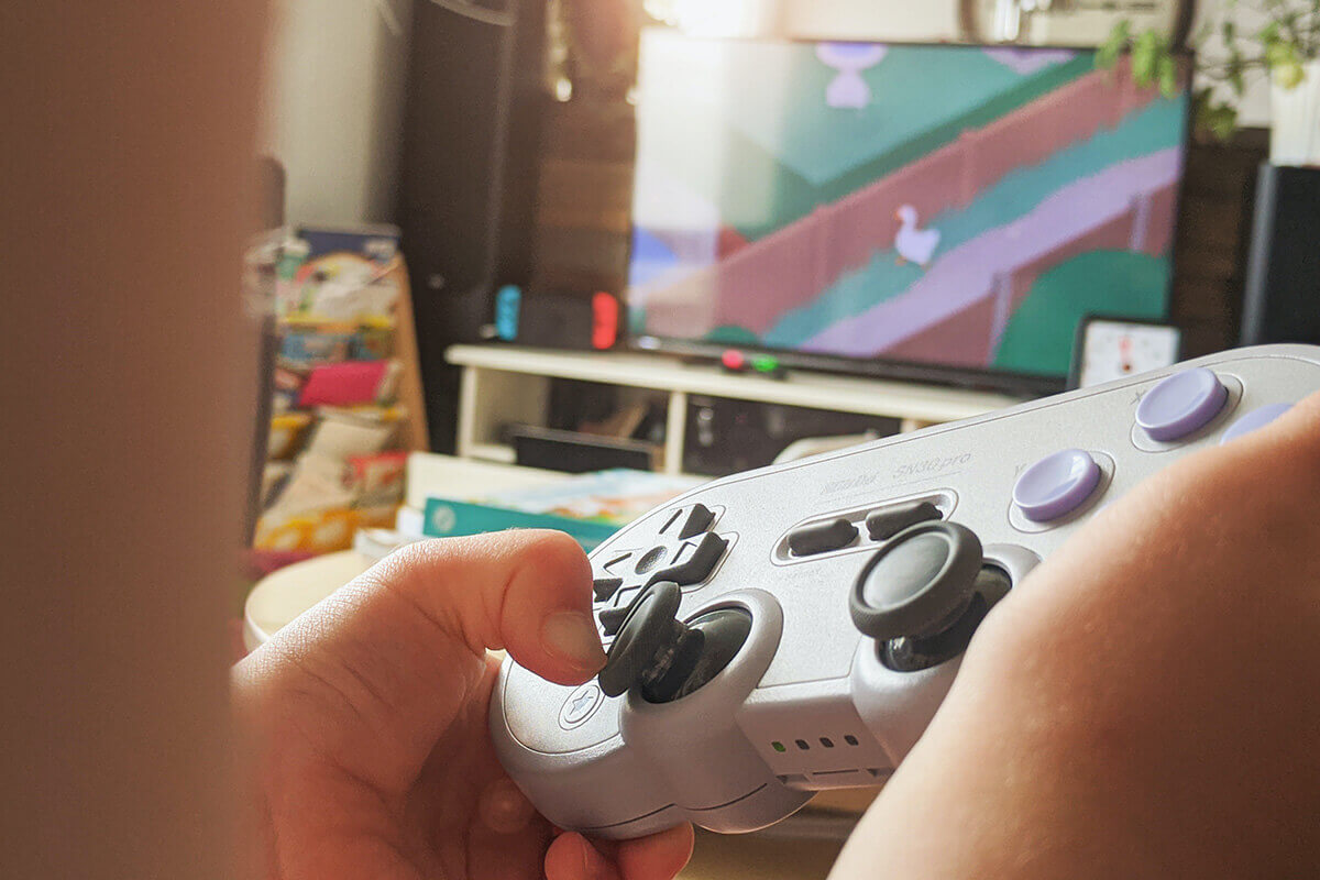 Close up of a retro looking gaming controller playing a game