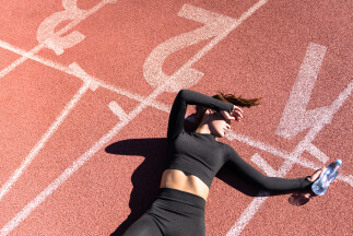 Woman laying on a running track