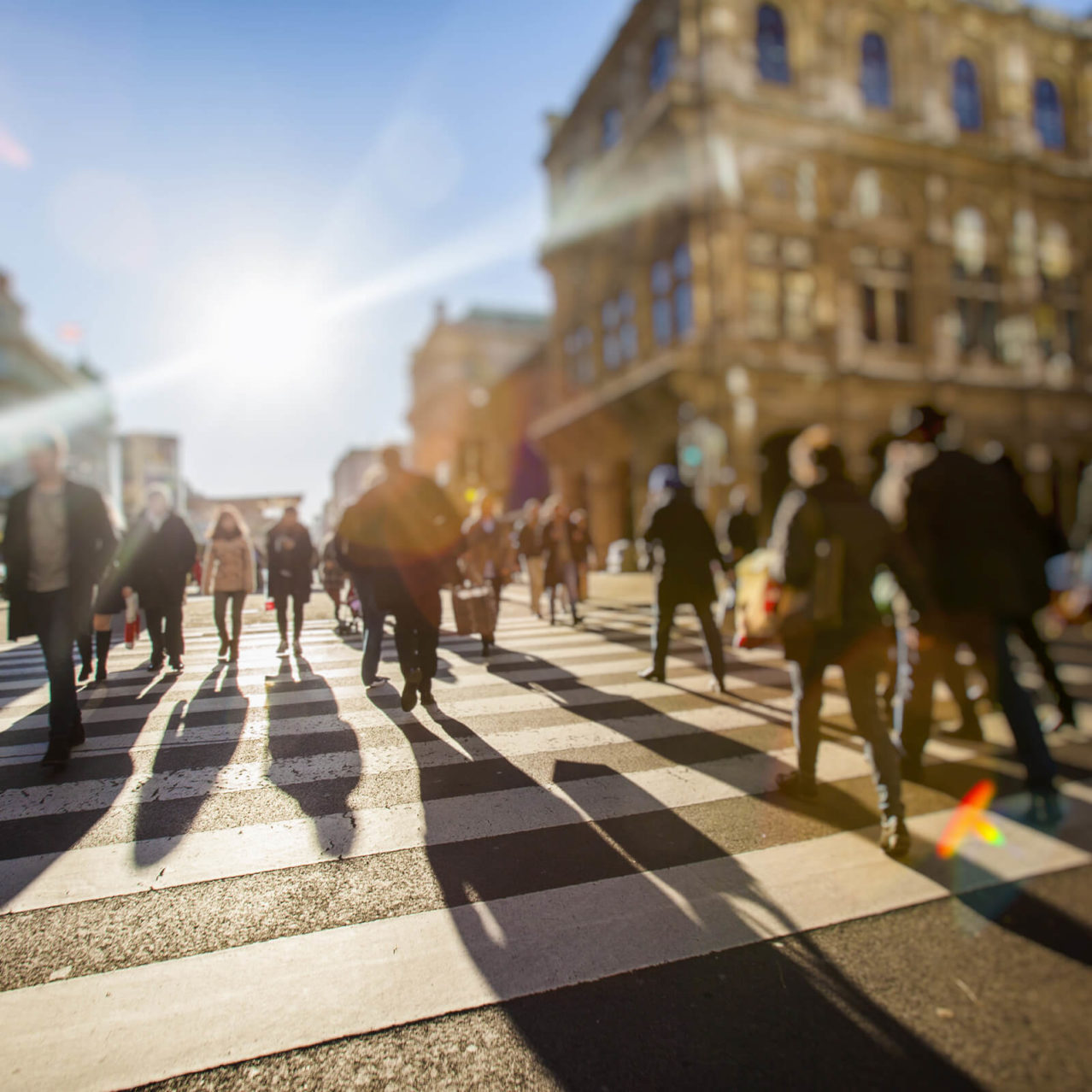 Blurred image of a busy pedestrian crossing in a city